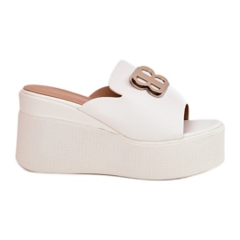 Slippers on the platform and wedges with a white ornament Slippers on the platform and wedges with a white ornament