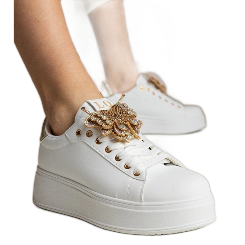 White and gold sneakers decorated with a butterfly with zircons White and gold sneakers decorated with a butterfly with zircons