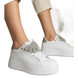White and silver sneakers decorated with a butterfly with zircons