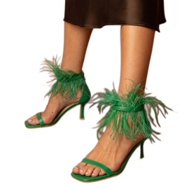 Green sandals on a pin with feathers Green sandals on a pin with feathers