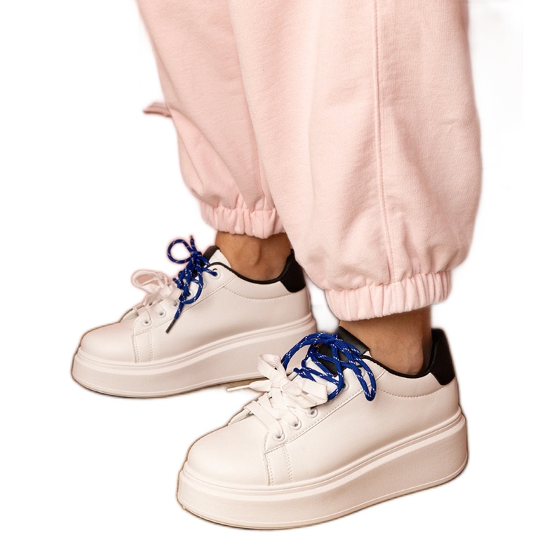 White sports sneakers on the platform White sports sneakers on the platform