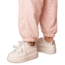 White and silver sports sneakers on the platform