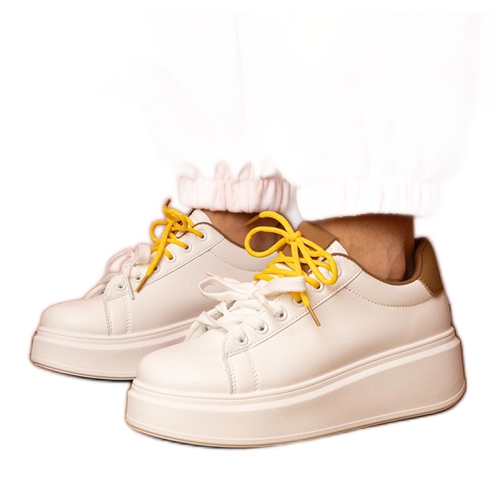 White-brown sports sneakers on the platform