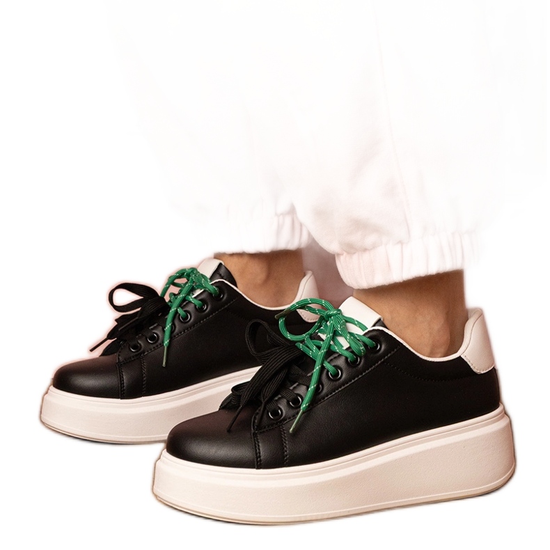 Black sports sneakers on the platform