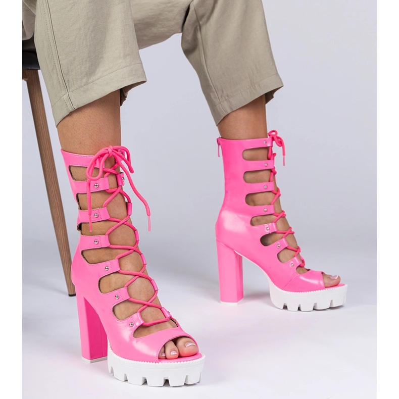 Pink boots on a high pillar with cutouts
