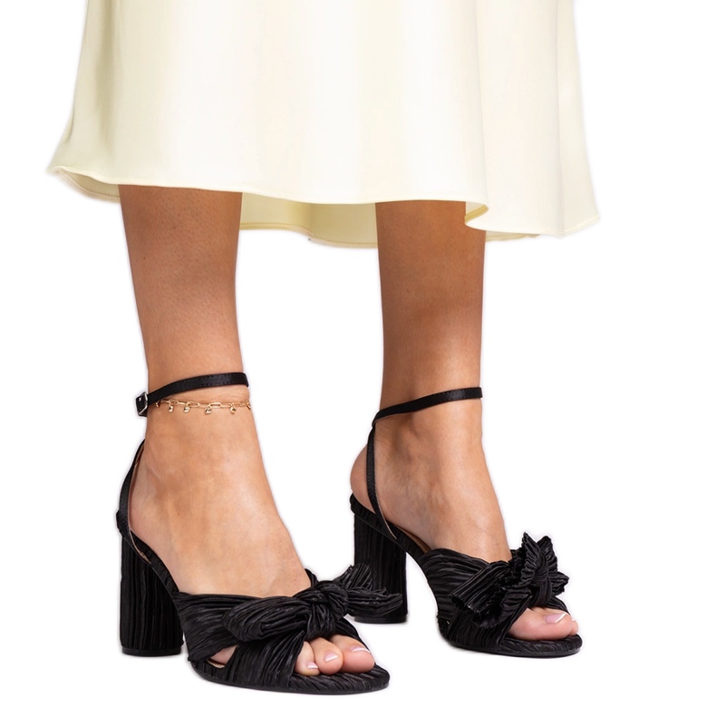 Black sandals with a bow on the block