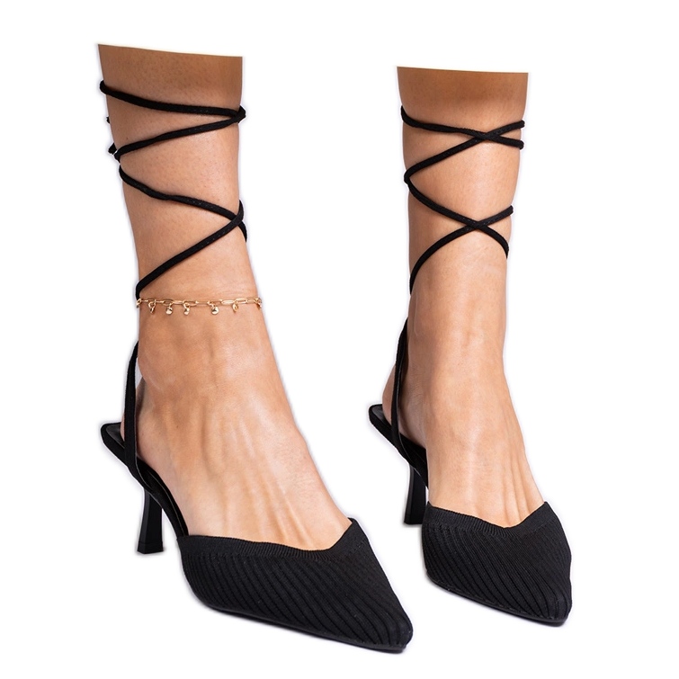 Black material pumps on a high heel with open