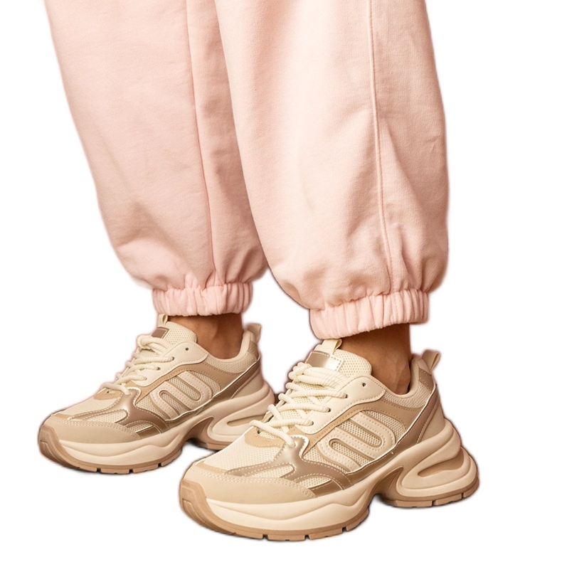 Beige sports sneakers on a massive sole
