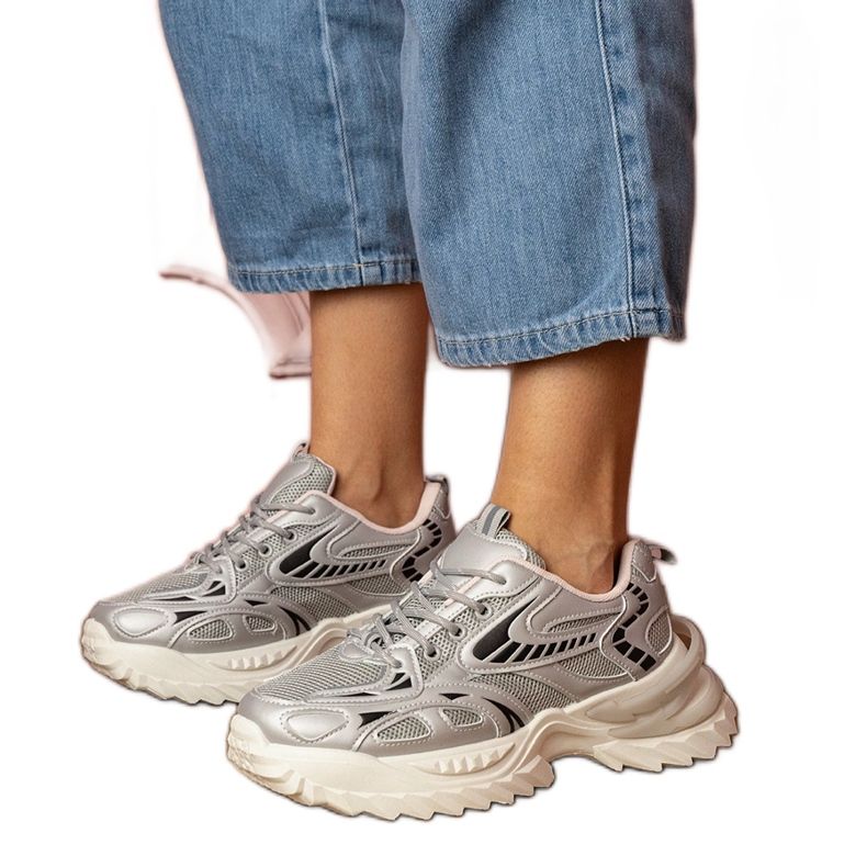 Silver sports sneakers on a stylish sole