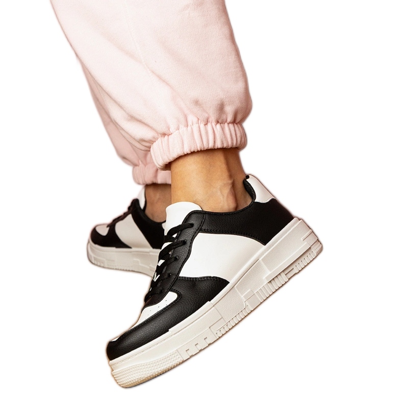 Black sports sneakers on platfotm