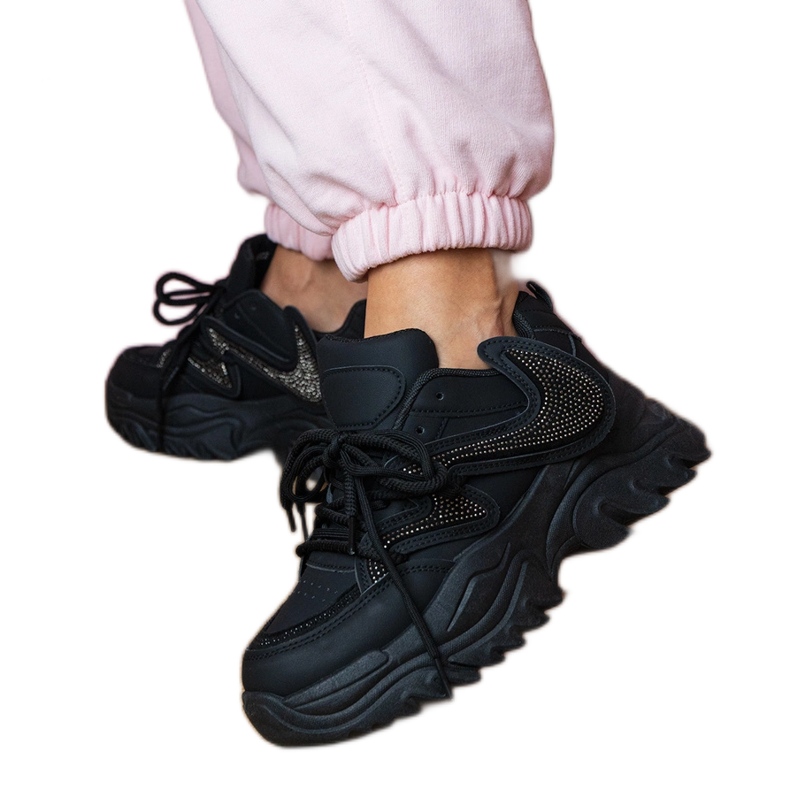 Black sneakers on a massive sole with zircons