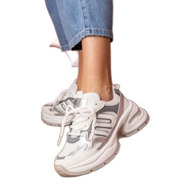 White sports sneakers with a massive sole