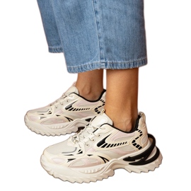 Beige sports sneakers on a stylish sole