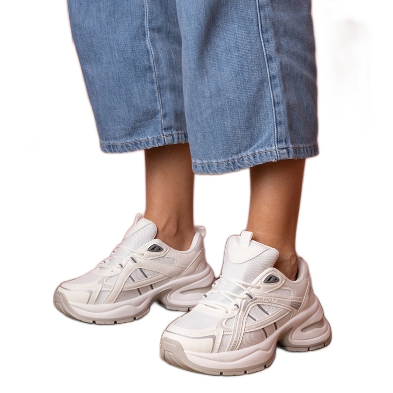 White sports sneakers with a massive sole