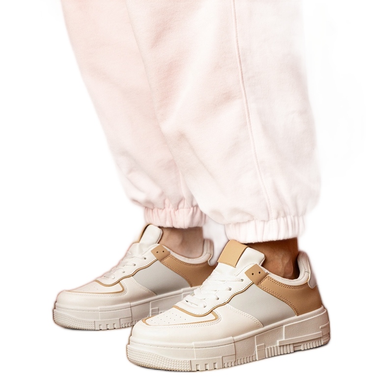 White and beige sports sneakers on platfotm