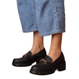 Black shoes on a low post with a golden decoration Black shoes on a low post with a golden decoration