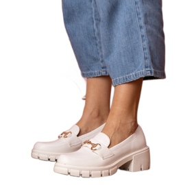 White shoes on a low post with a golden ornament White shoes on a low post with a golden ornament