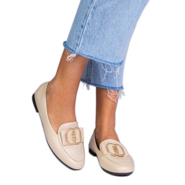 Beige women's loafers with a golden decoration