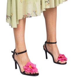 Black sandals on a heel decorated with a flower