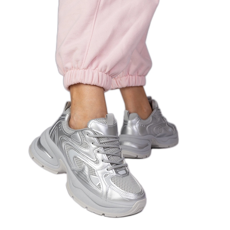Silver sports sneakers on a thick sole