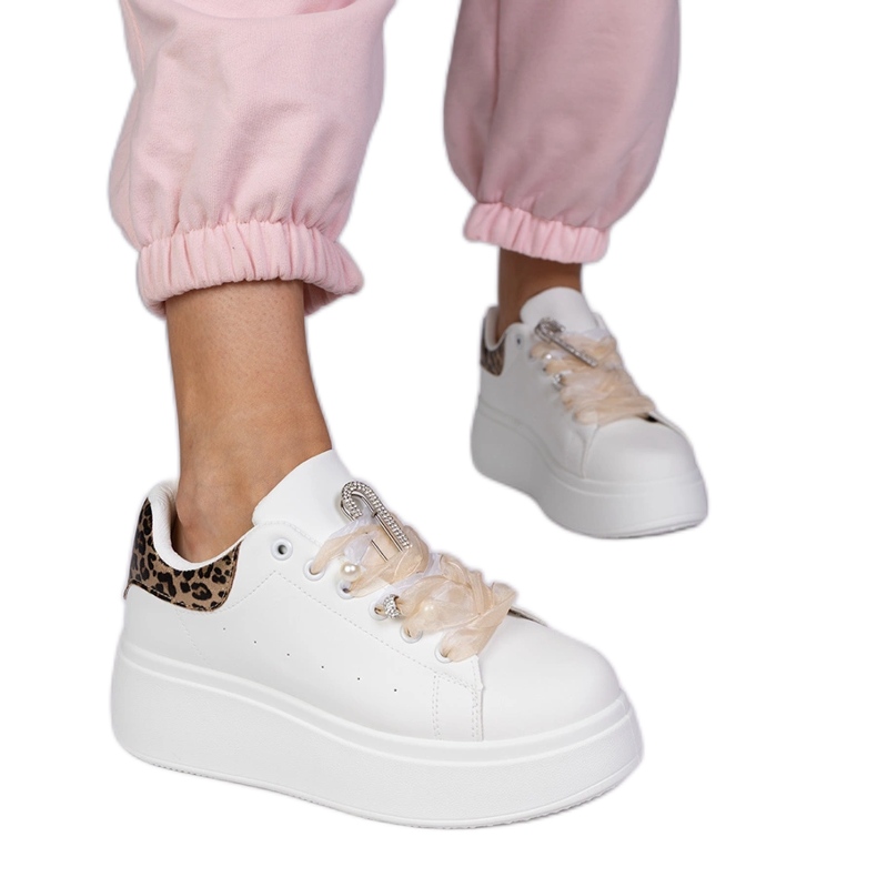 White sneakers with a leopard insert and a zircon pin