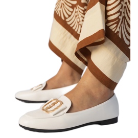 White women's loafers with a golden decoration