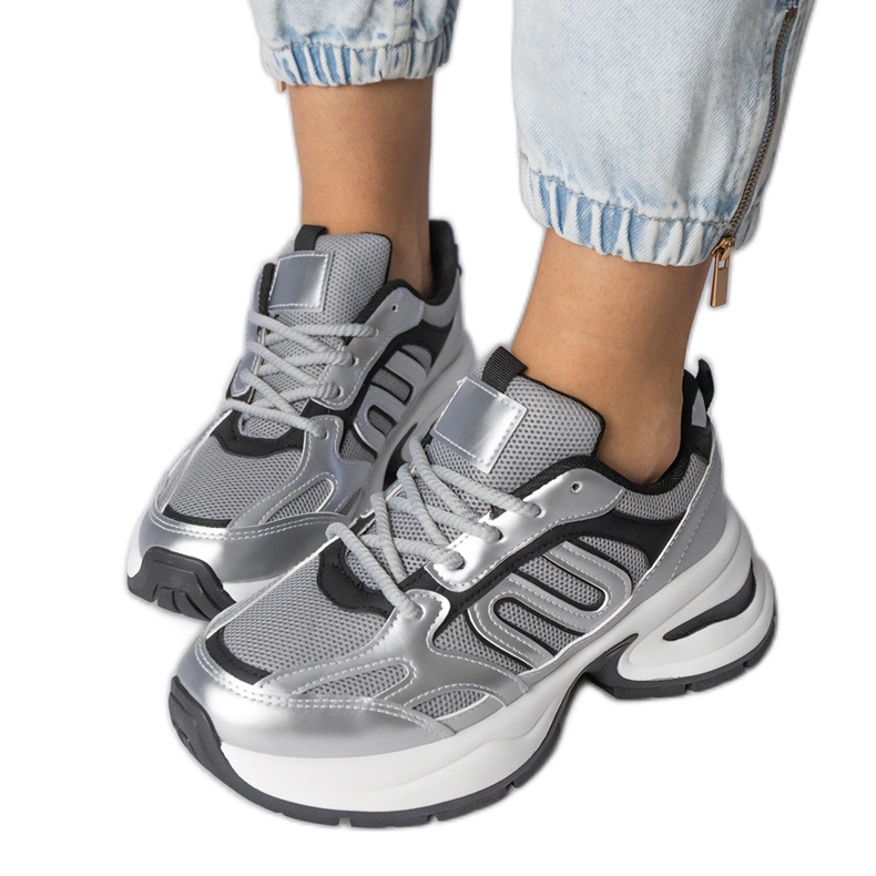 Silver sports sneakers on a massive sole
