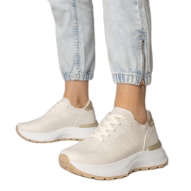 Beige sports sneakers with a golden insertion
