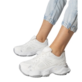 White sports sneakers with a massive sole