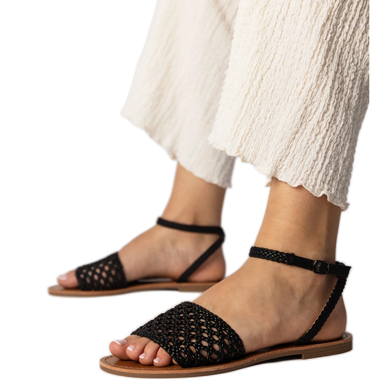 Black sandals woven on a flat sole
