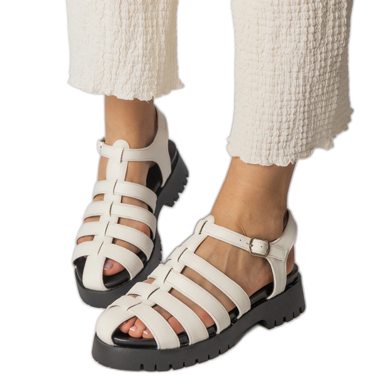 White sandals on the platform with a finger line