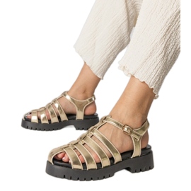 Gold sandals on the platform with a finger line built golden