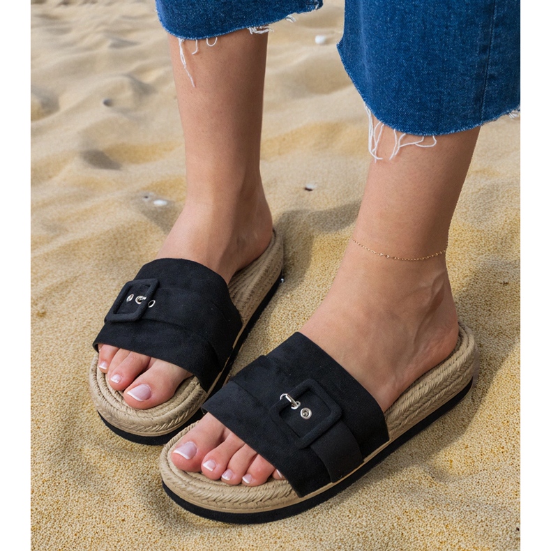 Black flip -flops on the platform with a decorative buckle