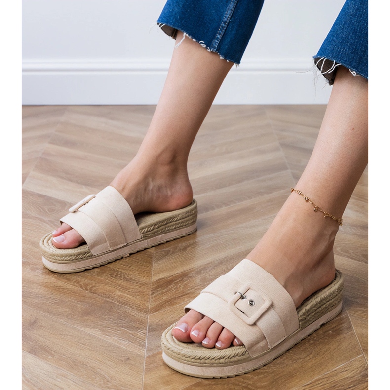 Beige flaps on the platform with a decorative buckle