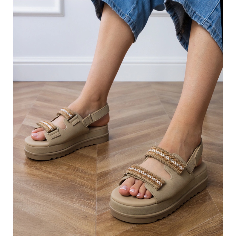 Brown sandals with embroidered straps on the platform