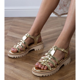 Golden women's sandals with a buckle