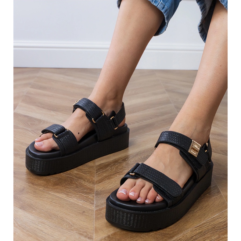 Black sandals on the platform with straps on the Velcro