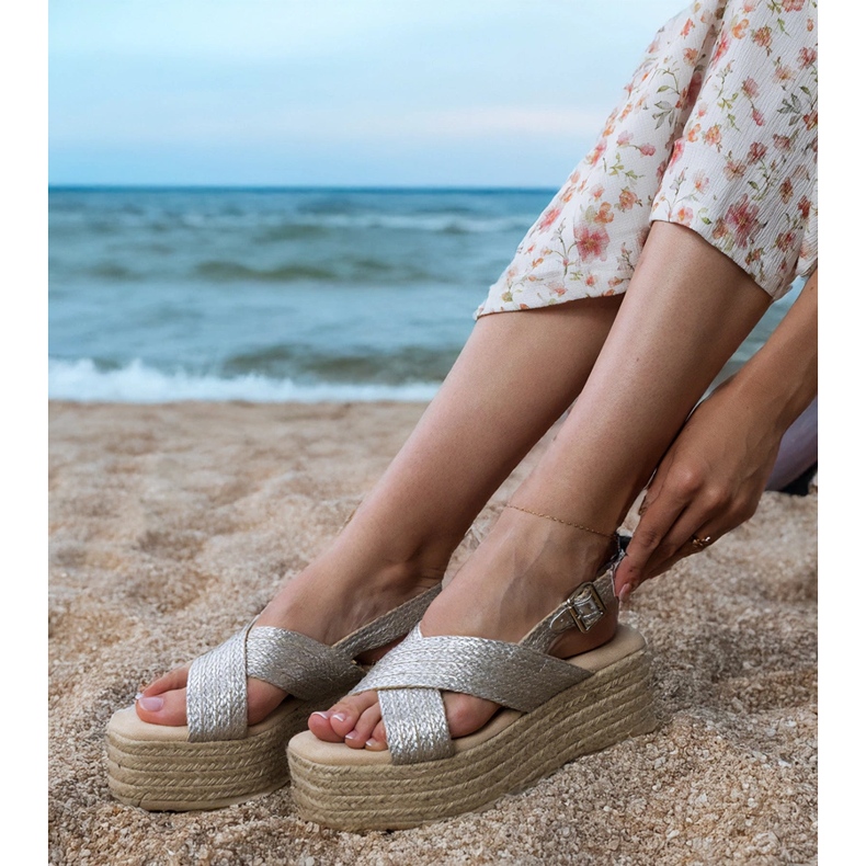 Silver espadrille sandals on a platform with stripes