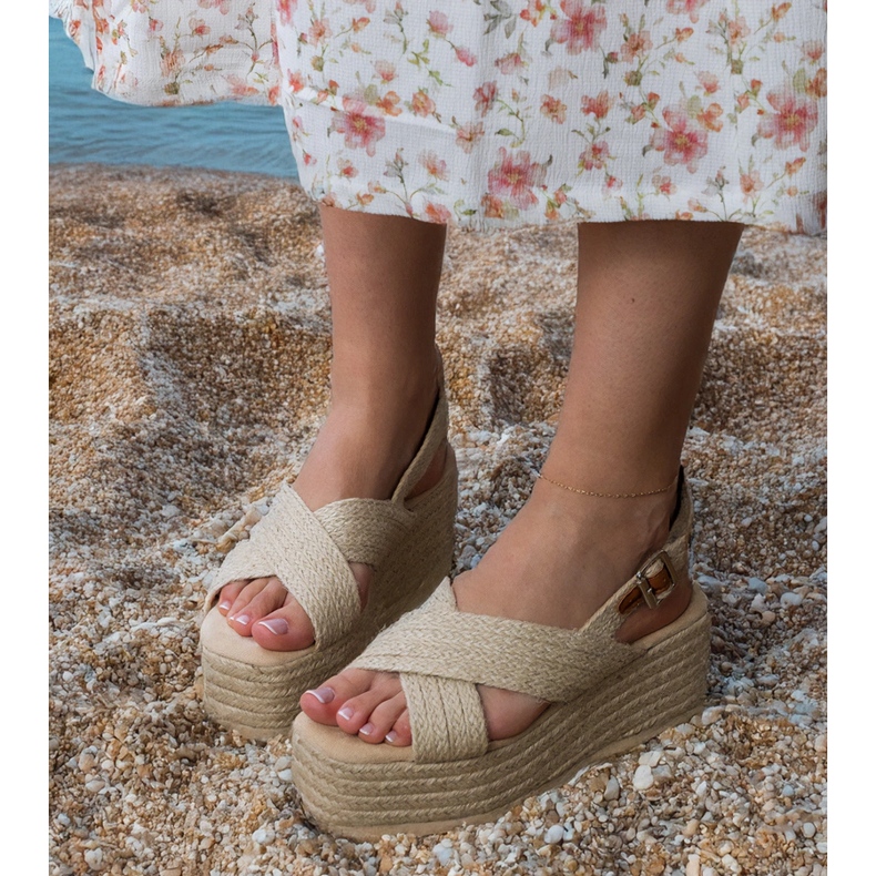 Beige espadrilles sandals on a platform with stripes