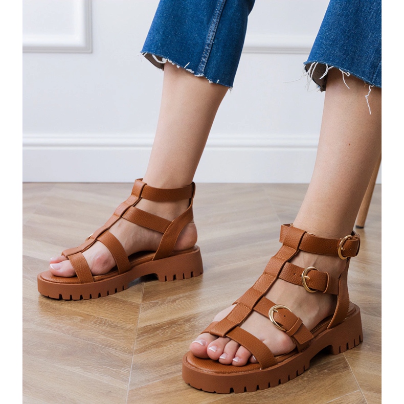 Brown gladiator sandals fastened with a cube