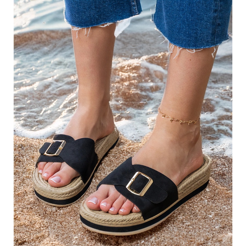 Black flip flops on the platform with a buckle on the belt