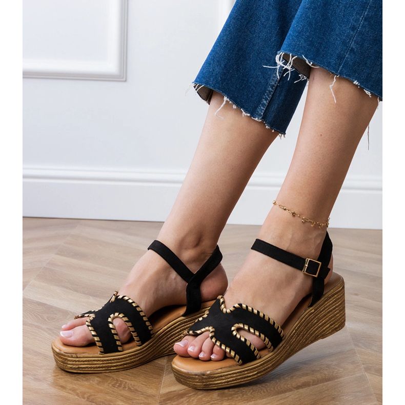 Black sandals with embroidery on the edges