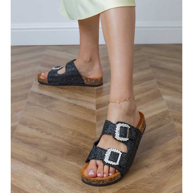 Black flip flops on the cork sole with zircons on the buckles