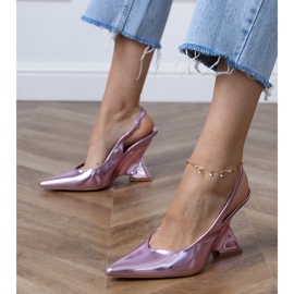 Purple sandals on a geometric wedge