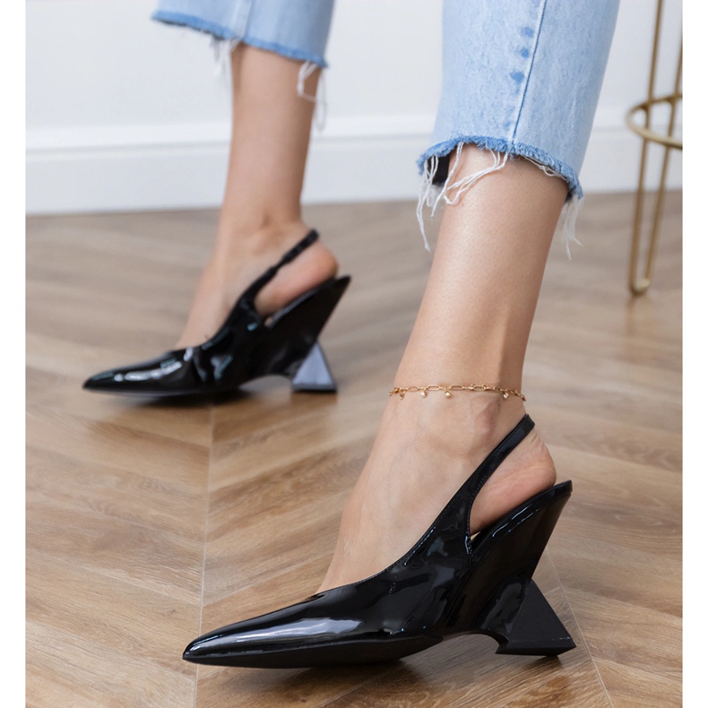 Black sandals on a geometric wedge