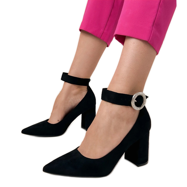 Black pumps on the post with a buckle and zircons