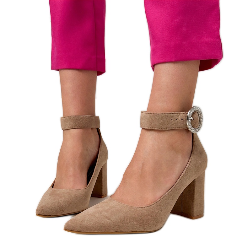 Beige pumps on the post with a buckle and zircons