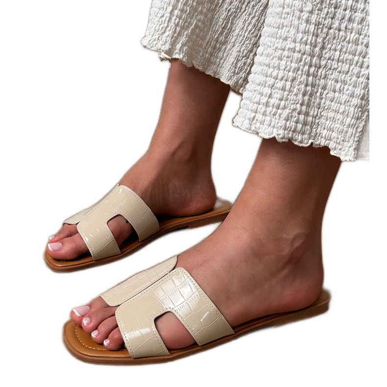 Beige flaps on a flat sole with pressing