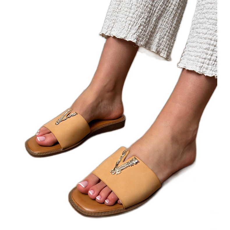 Beige flip flops with a golden decoration