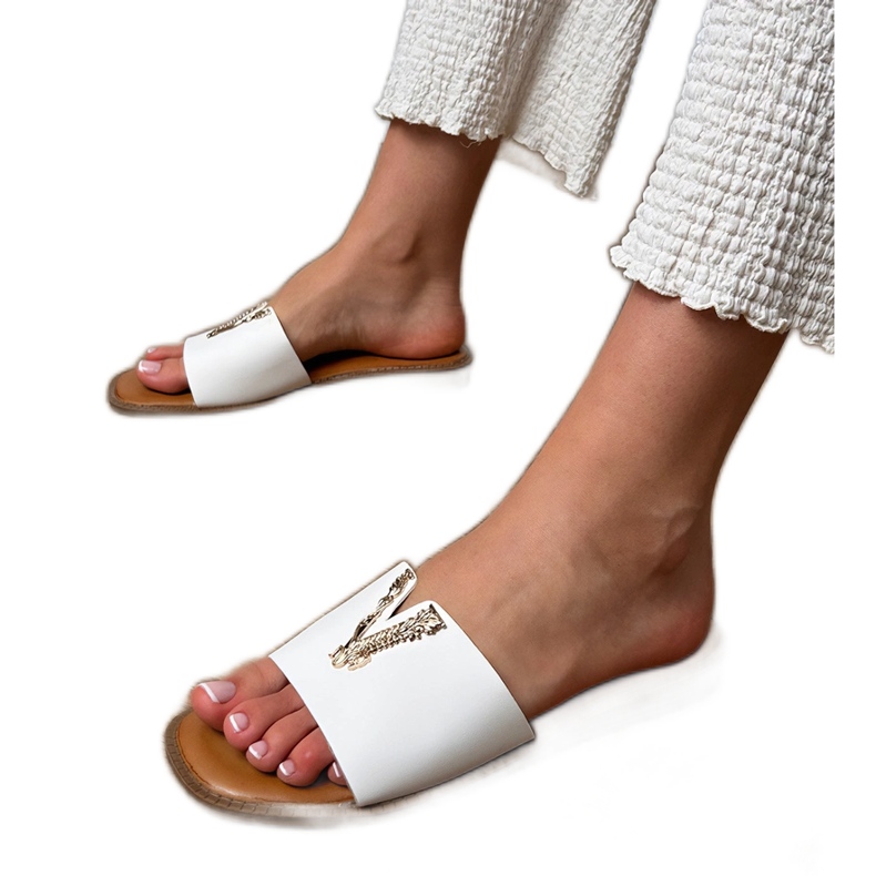 White flip flops with a golden decoration